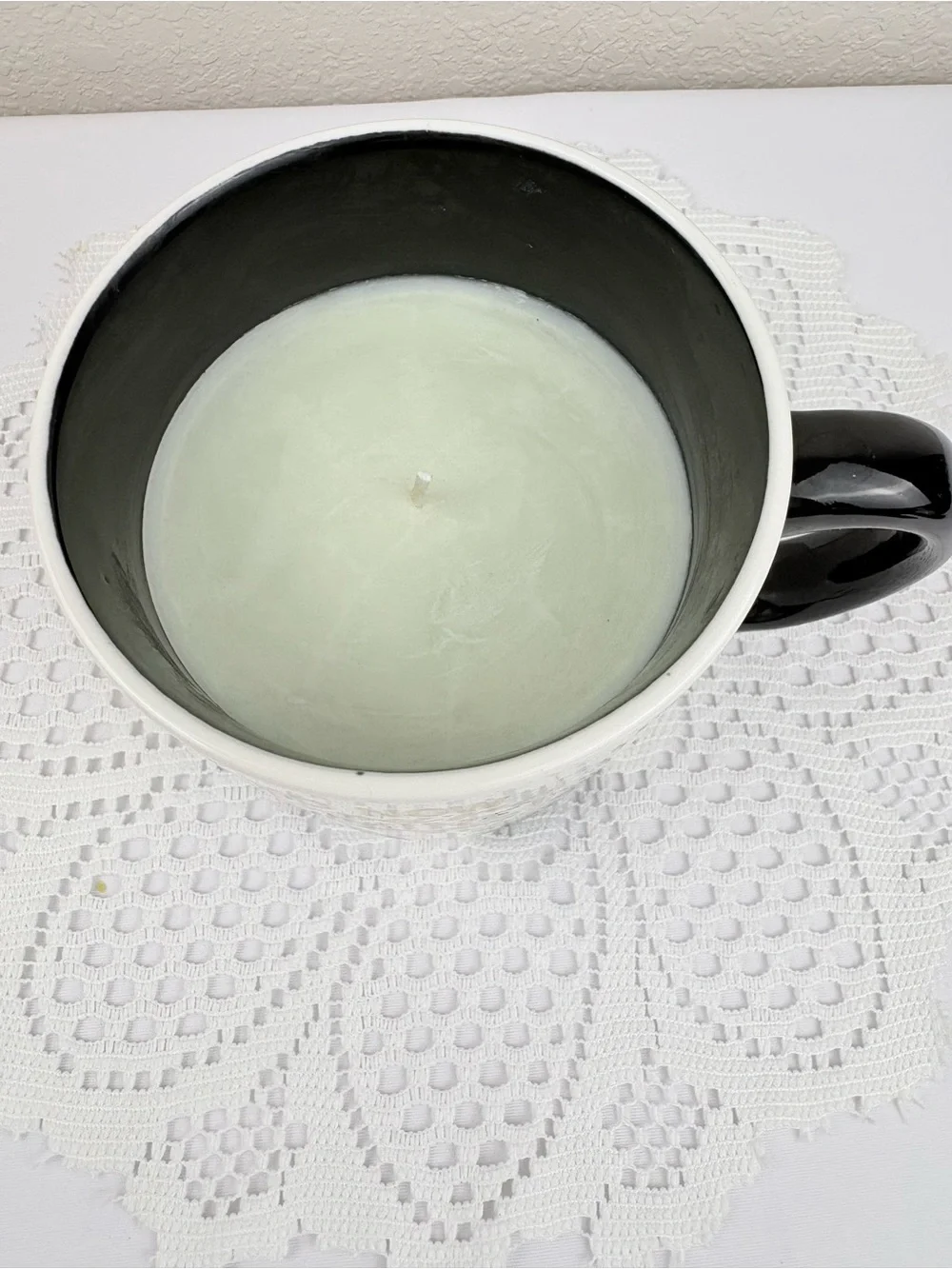 Disney Hocus Pocus Ceramic Mug with a Candle Inside the Mug.